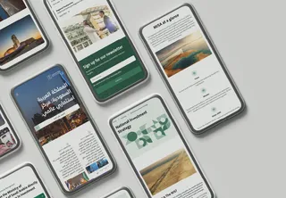 MISA Invest Saudi website on several tilted phone screens in green, with Arabic and English pages
